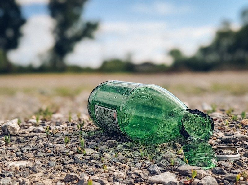 Close-up of a broken glass bottle on the ground. Glass being dumped instead of recycled credit Ivan Radic