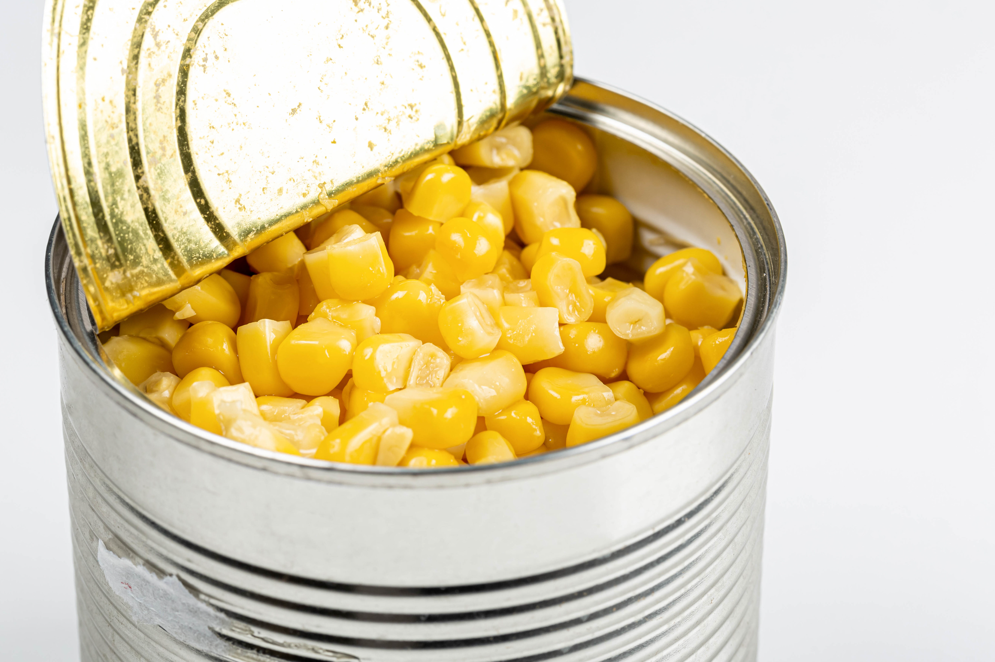 Open tin can with corn kernels on white background credit Marco Verch CC BY 2.0